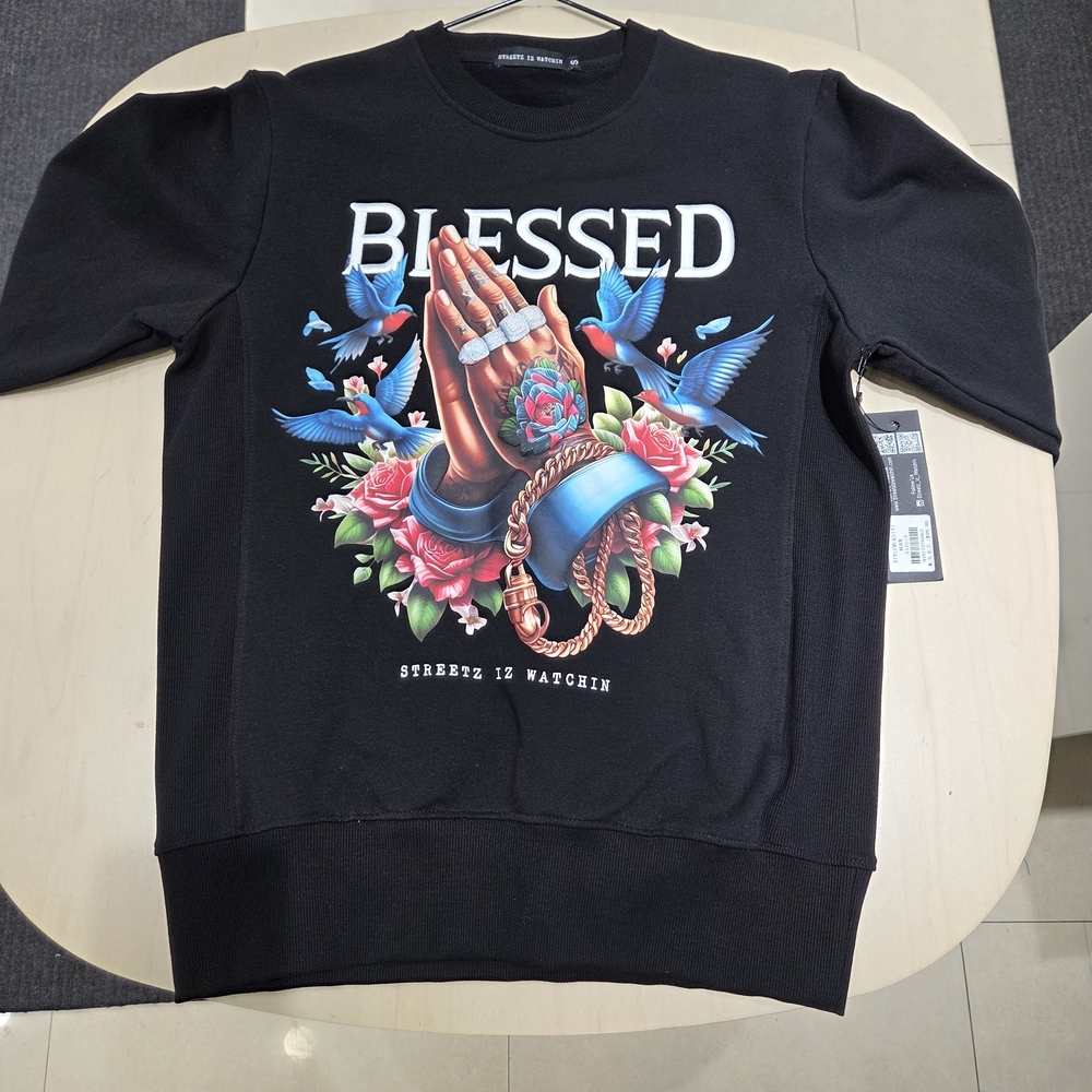 Streetz is watchin Black ‘BLESSED’ Crewneck Sweatshirt with Prayer Hands Graphic